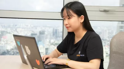 woman in black shirt using gray laptop computer
