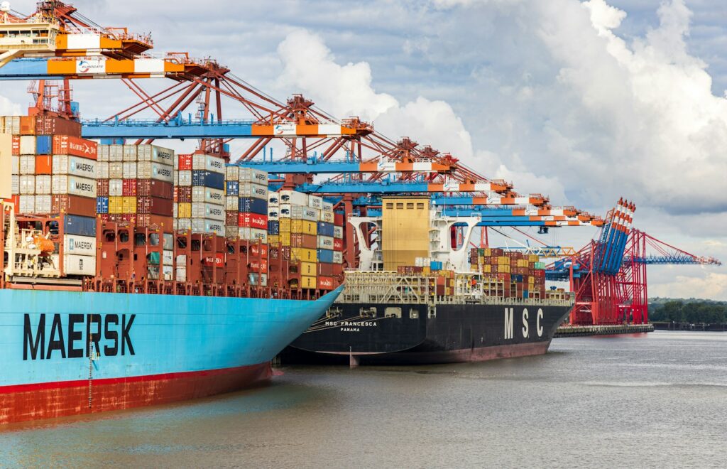 blue and red cargo ship on dock during daytime